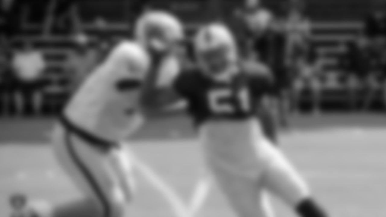 Oakland Raiders offensive tackle Kolton Miller (77) and outside linebacker Bruce Irvin (51) on the field for practice at 2018 Training Camp at The Oakland Raiders Napa Valley Training Complex, Thursday, August 2, 2018, in Napa, California.