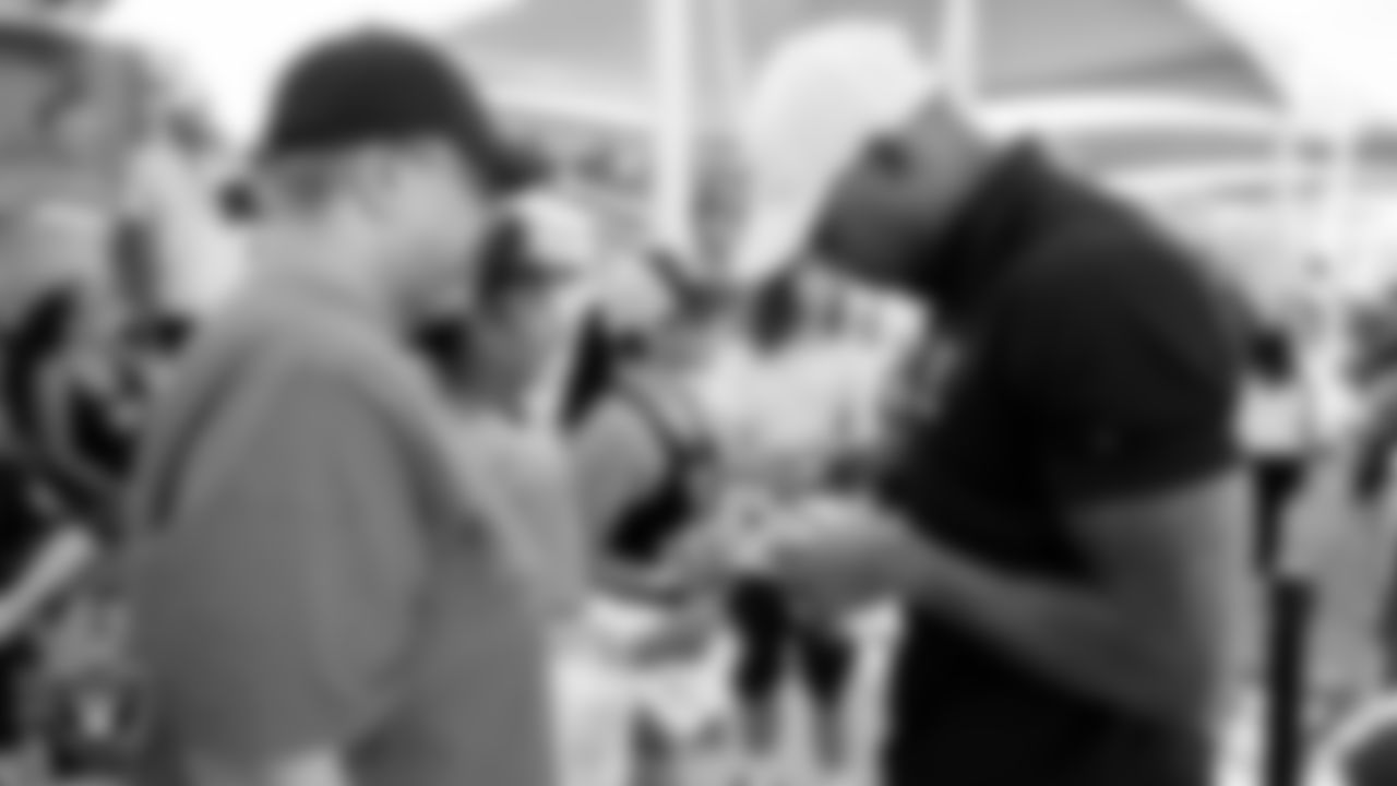 Las Vegas Raiders alumnus Korey Toomer signs autographs for fans before practice at 2023 Training Camp at Intermountain Health Performance Center.