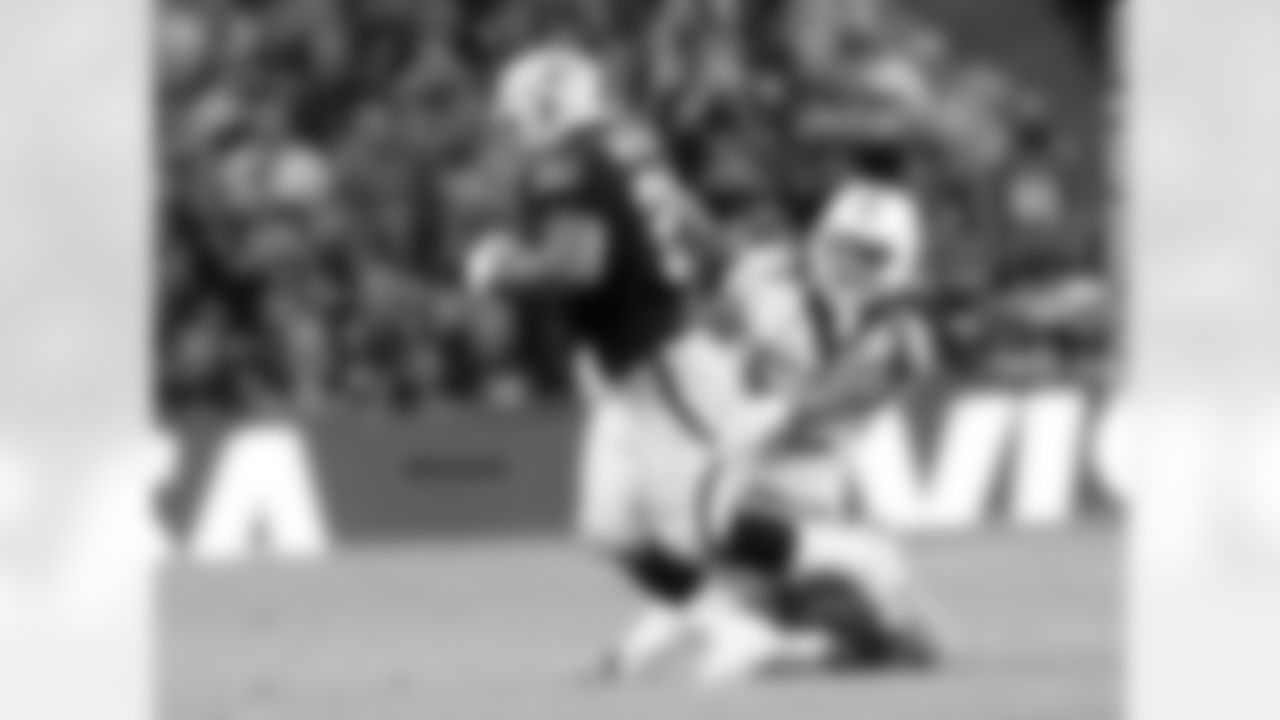 RB Maurice Jones-Drew tries to get out of a tackle by LB Philip Wheeler.