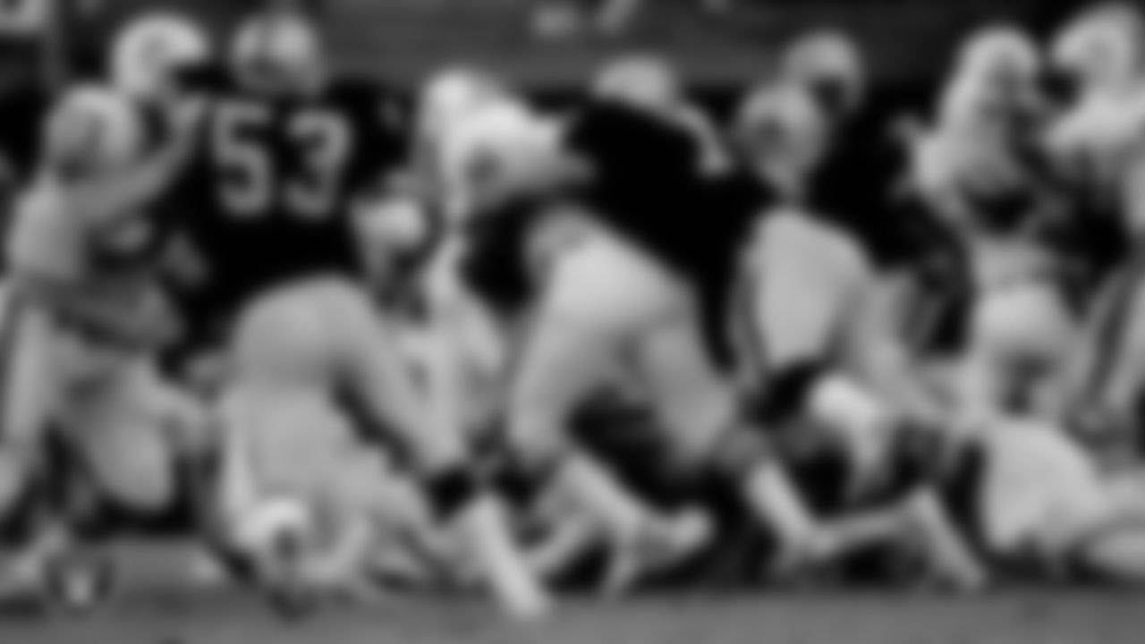 Raiders defensive end Lyle Alzado (77) makes a tackle during the regular season away game against the Miami Dolphins at the Miami Orange Bowl, Sunday, December 2, 1984, in Miami, Fla.