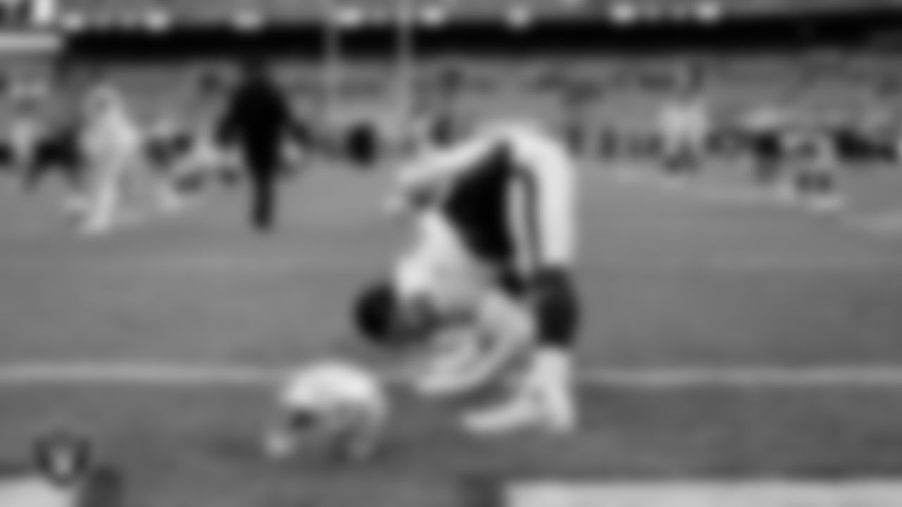The Raiders warm up before the regular season game against the Cleveland Browns at FirstEnergy Stadium.