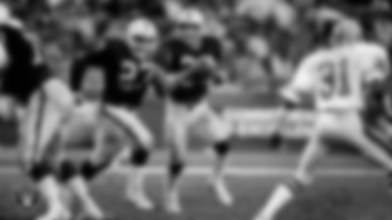 Raiders running back Marcus Allen (32) rushes behind running back Frank Hawkins (27) during the regular season home game against the Denver Broncos at Los Angeles Memorial Coliseum, Sunday, November 24, 1985, in Los Angeles, Calif.