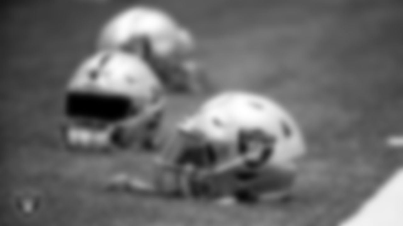 Las Vegas Raiders helmets on the field for a walkthrough.