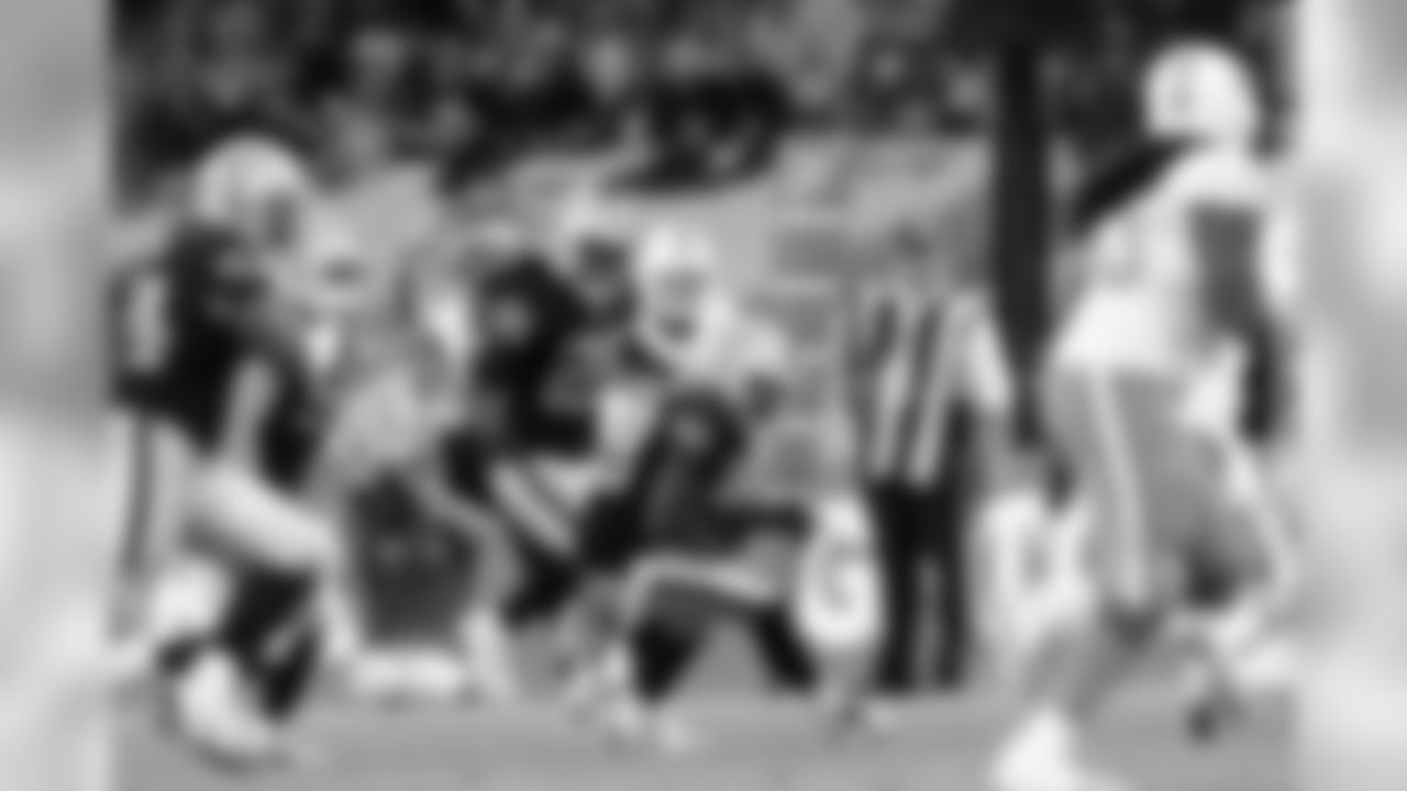 CB TJ Carrie intercepts QB Ryan Tannehill.