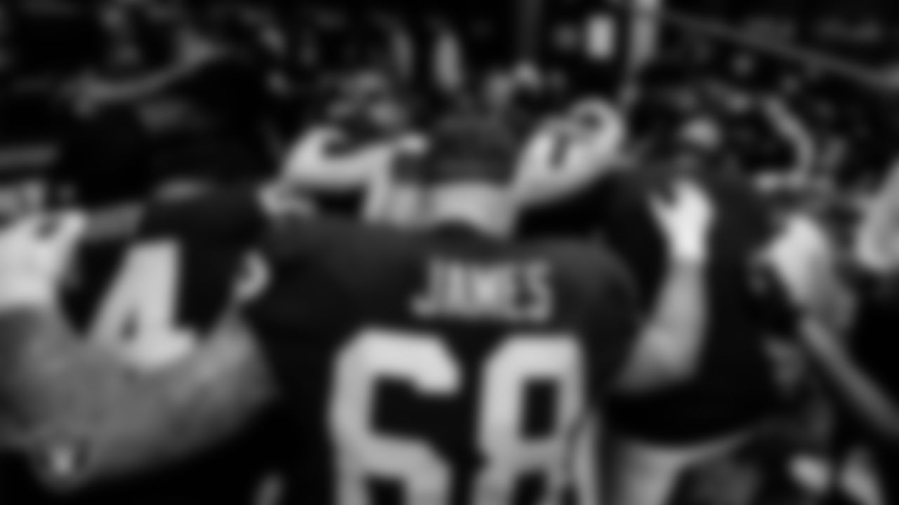The Las Vegas Raiders huddle in the locker room after the regular season home game against the New England Patriots at Allegiant Stadium.