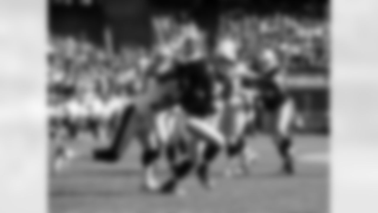 WR Denarius Moore hangs on to the ball with the defender all over him.