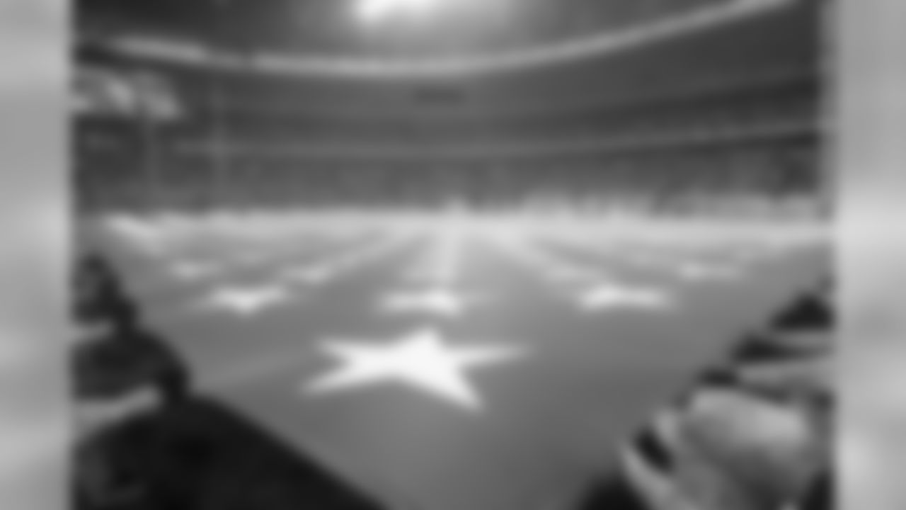 The American flag is unfurled on the field for the National Anthem.