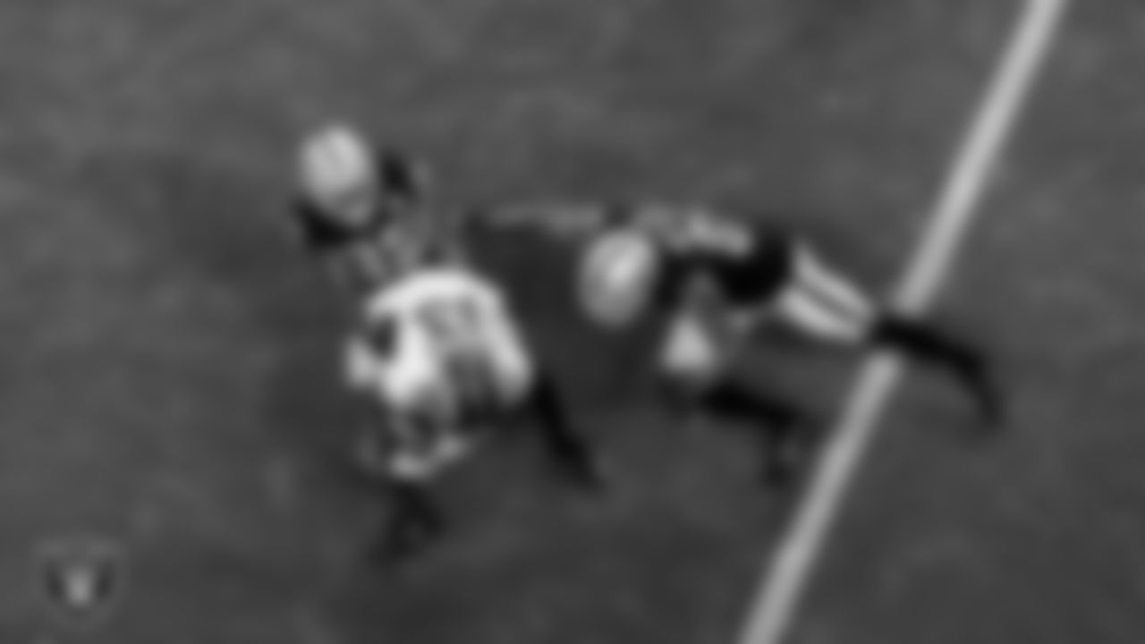 Las Vegas Raiders safety Lamarcus Joyner (29) and cornerback Trayvon Mullen (27) make a tackle during the regular season home game against the Denver Broncos.