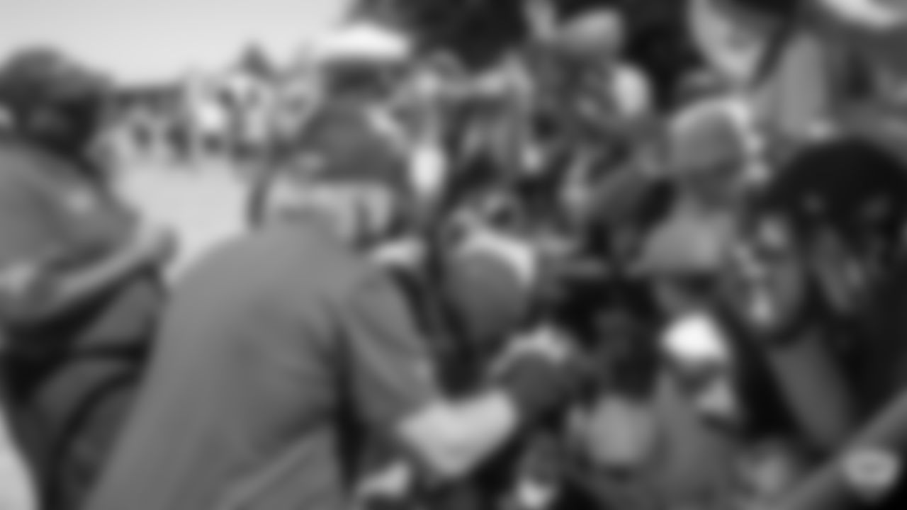 Raiders head coach Jon Gruden signs autographs for fans after practice at 2019 Training Camp.