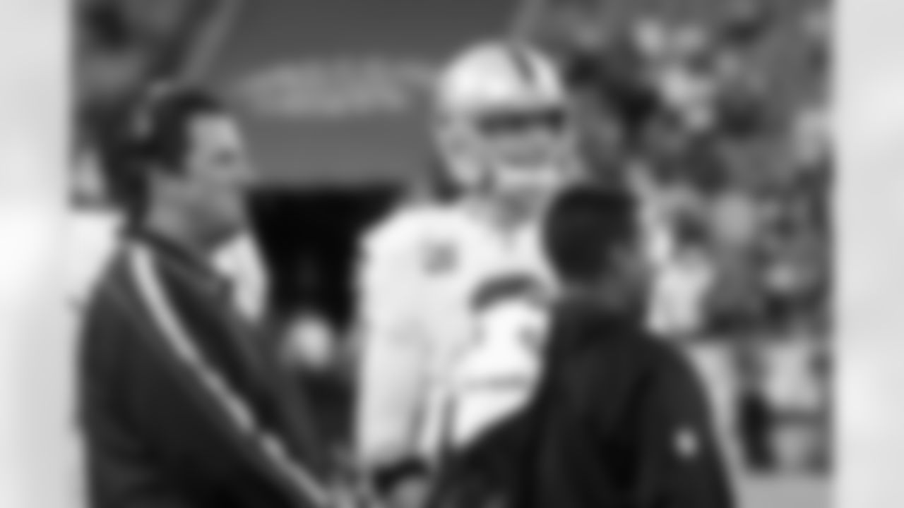 QB Carson Palmer and offensive coordinator Greg Knapp look up at the scoreboard.