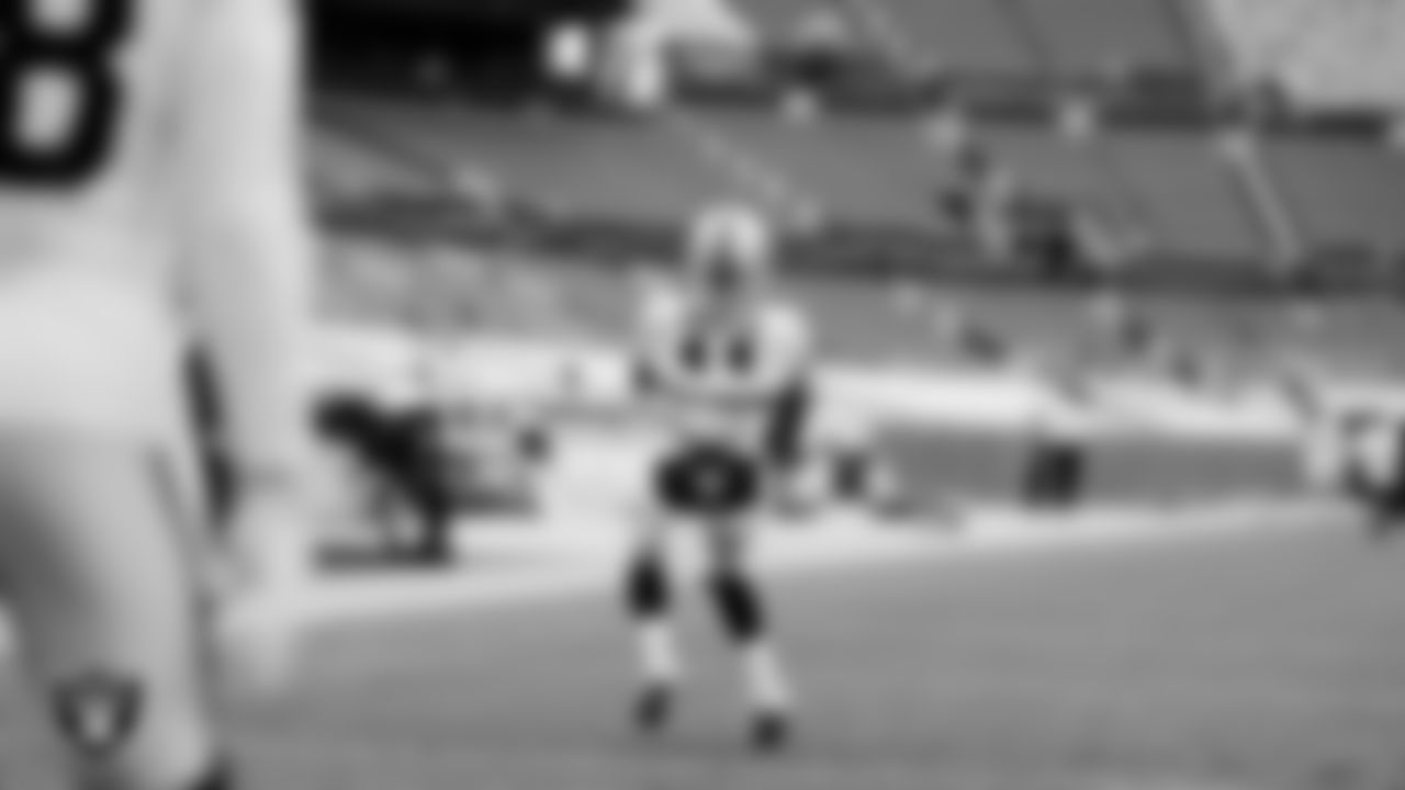 The Raiders warm up before the regular season game against the Denver Broncos at Empower Field at Mile High.