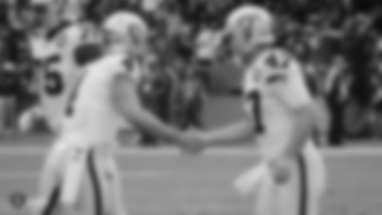 Raiders quarterback Derek Carr (4) celebrates with long snapper Trent Sieg (47) during the regular season game against the Los Angeles Chargers.