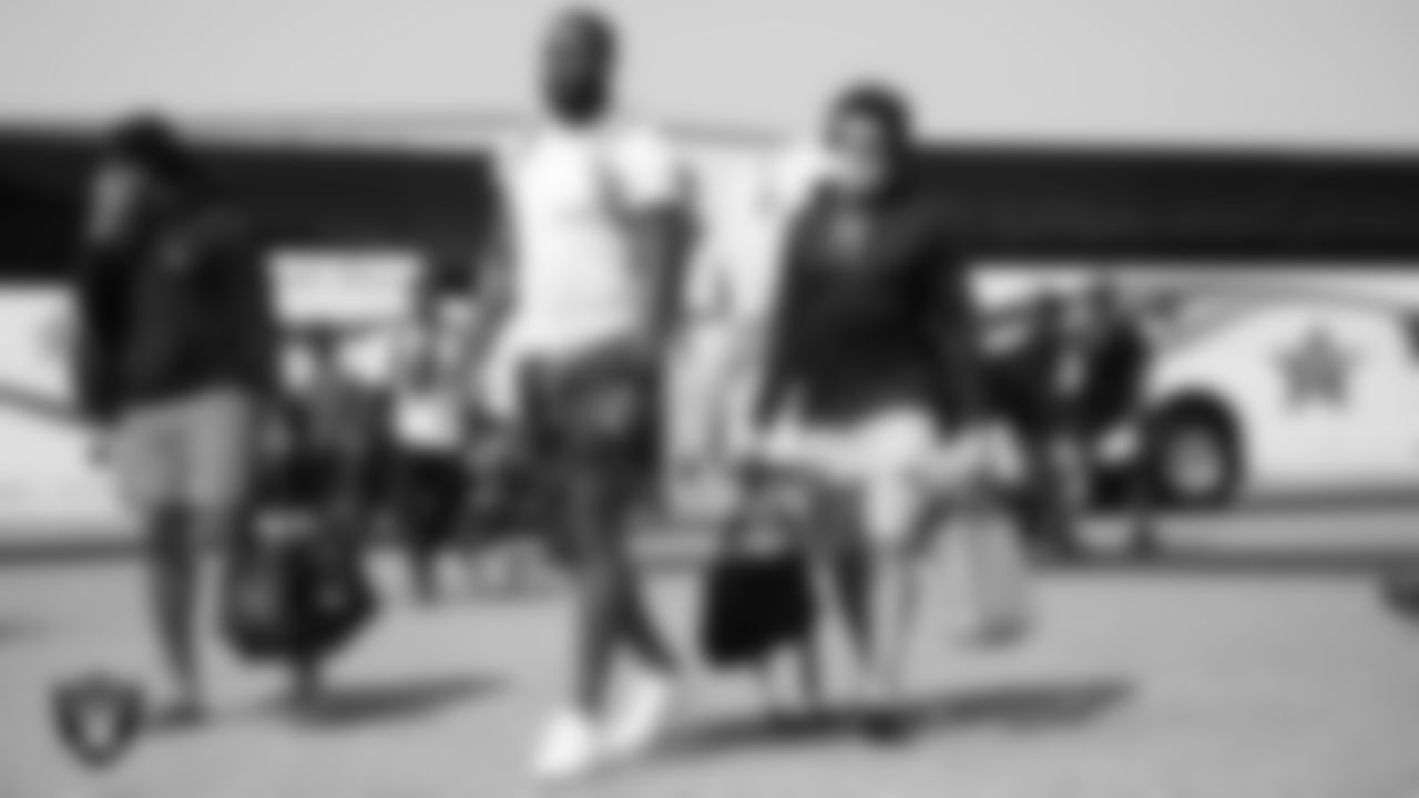 Las Vegas Raiders defensive end Gerri Green (52) and wide receiver Willie Snead IV (17) depart for the joint training camp practice and preseason away game against the Los Angeles Rams.