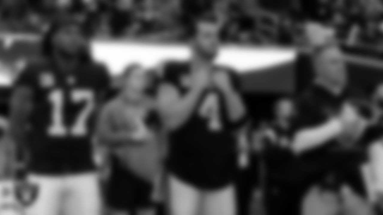 Las Vegas Raiders wide receiver Davante Adams (17), quarterback Derek Carr (4) and Head Coach Josh McDaniels during the national anthem before the regular season home game against the Indianapolis Colts at Allegiant Stadium.