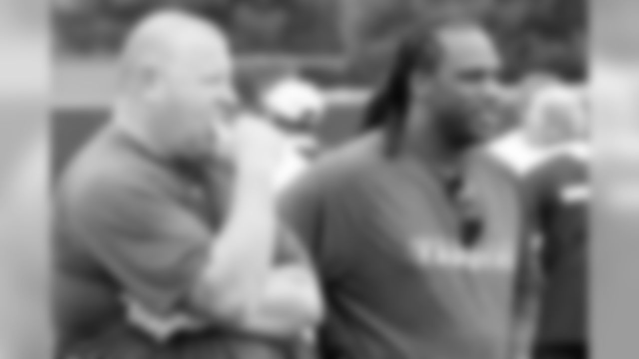 Head Coach Tom Cable and former FB Zach Crockett look on from the sideline. Photo By Tony Gonzales
