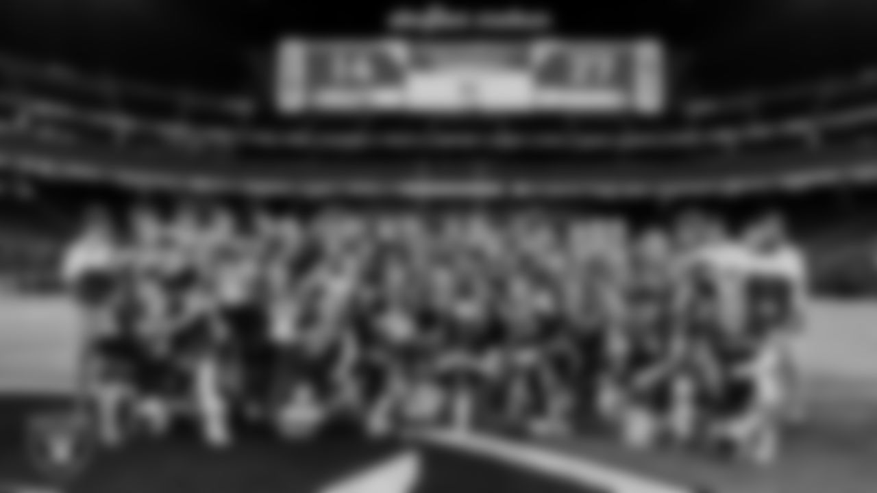 The Moapa Valley High School football team and coaches pose for a photo following their win against Virgin Valley High School during the NIAA Class 3A State Football Championship at Allegiant Stadium.
