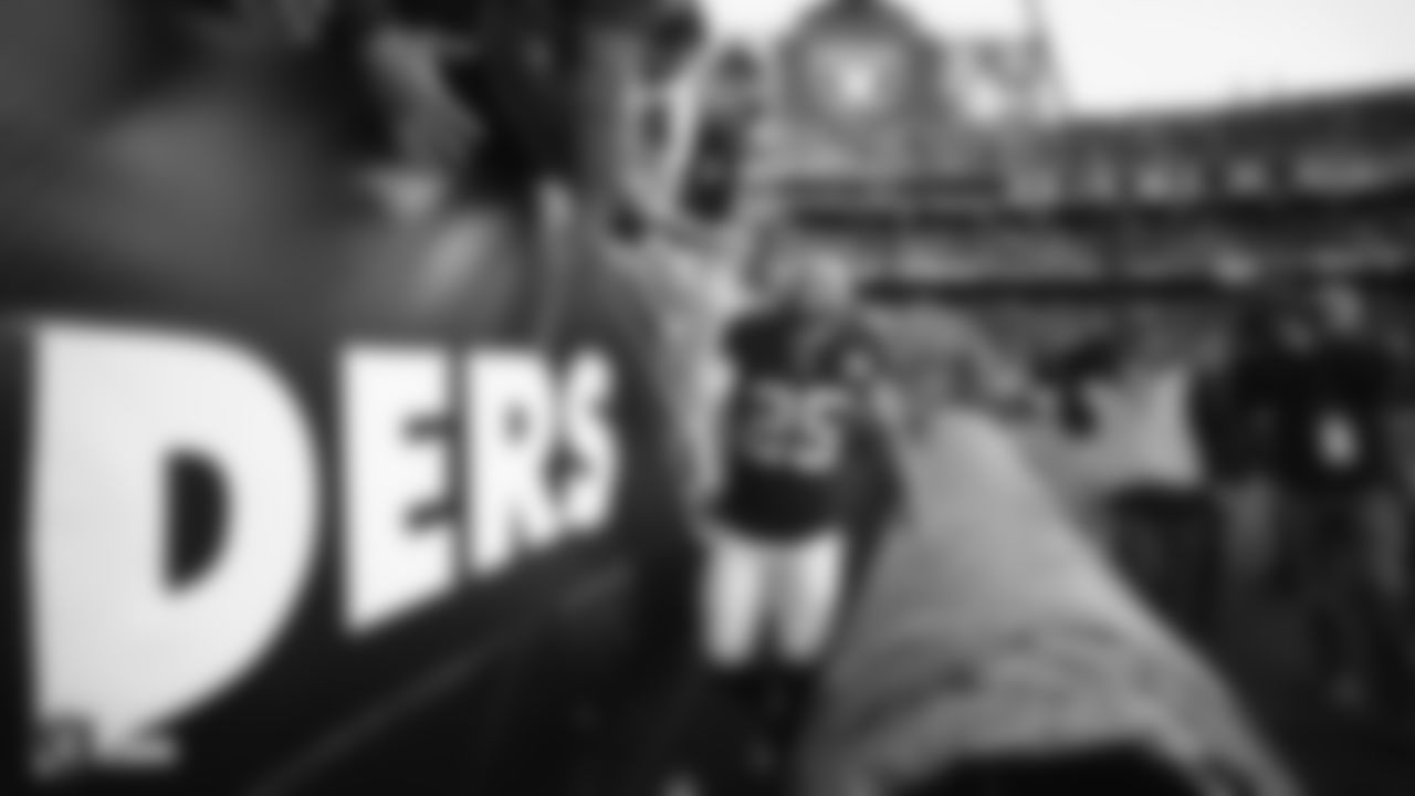 Raiders safety Erik Harris (25) high fives fans after the regular season game against the Jacksonville Jaguars.