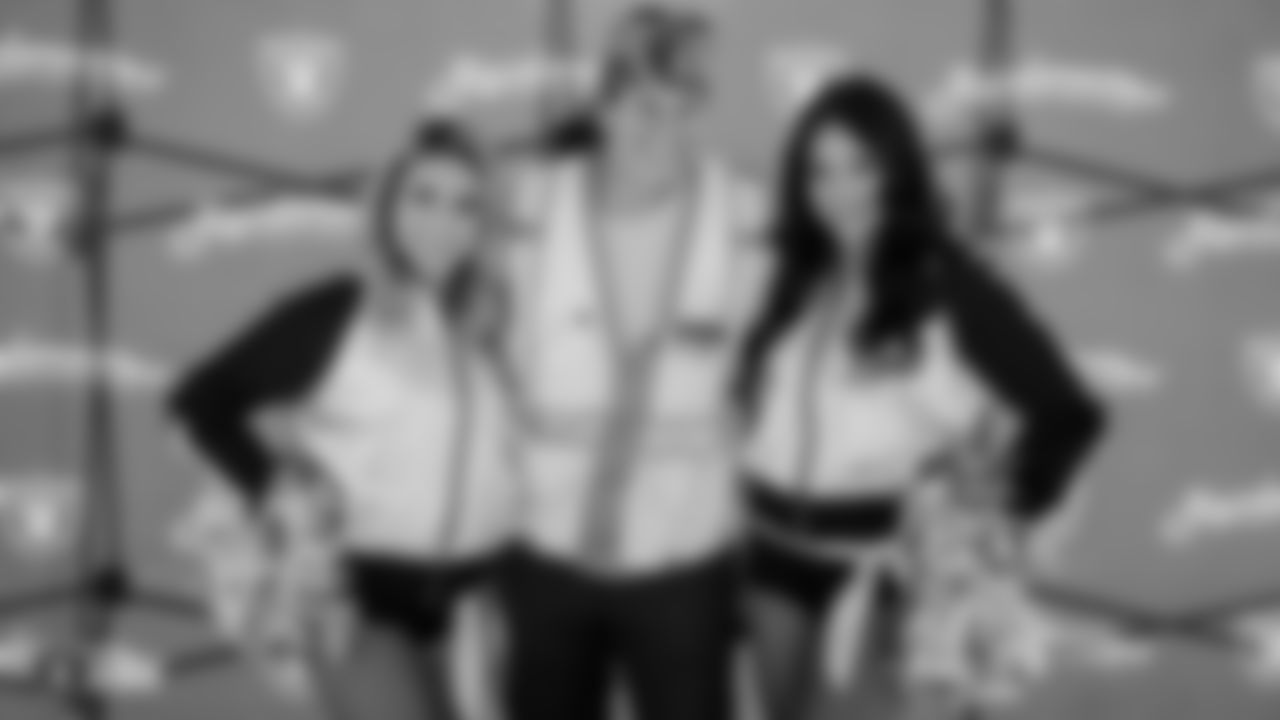 Raiderettes Julia and Audrey pose for a photo with a construction worker of the Raiders Headquarters and Intermountain Healthcare Performance Center worksite during a lunch hosted by the Raiders front office.