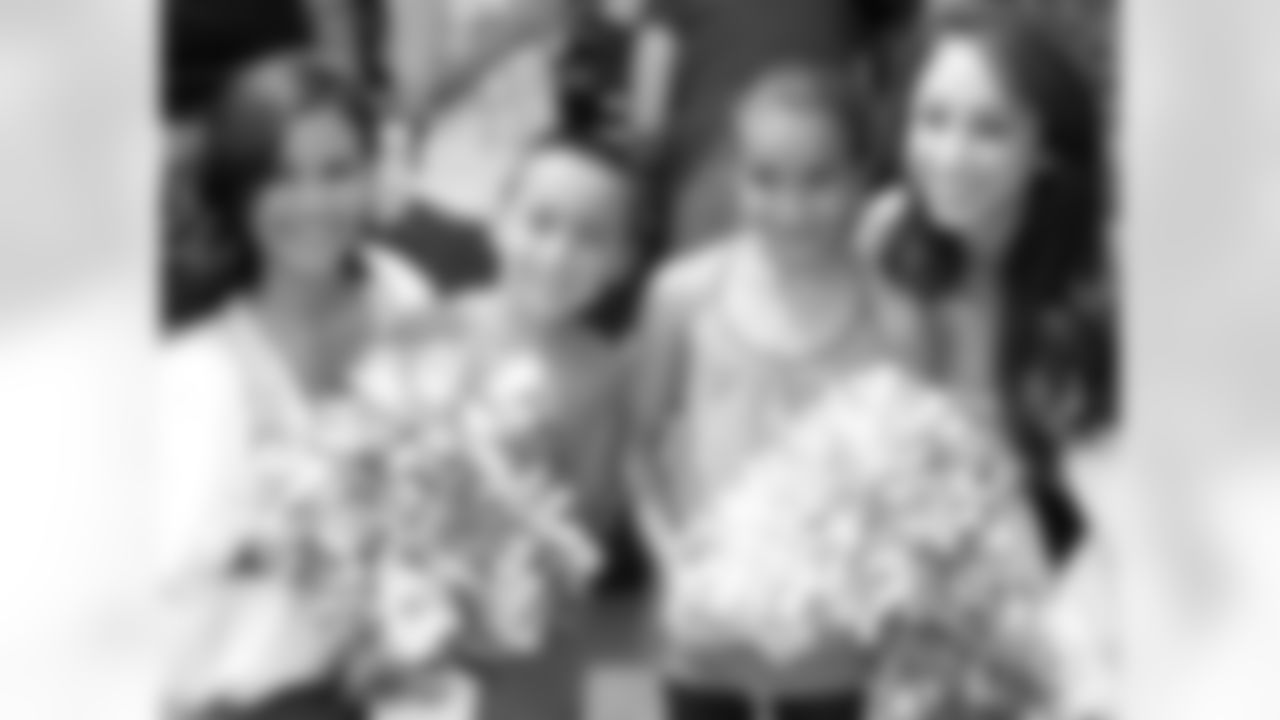 Raiderettes Brandi and Sarah Marie pose for a photo with young fans.