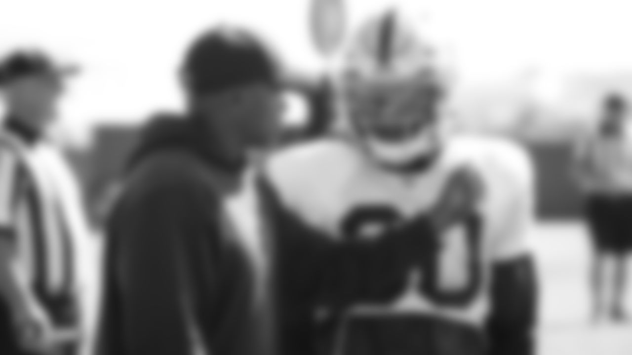 Raiders running backs coach Kirby Wilson talks with running back Jalen Richard (30) during practice.