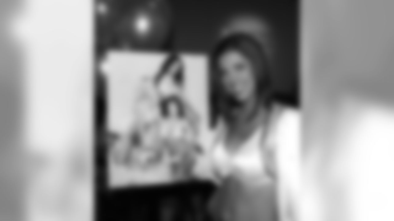 Raiderette Mallorie stands with her calendar photo.