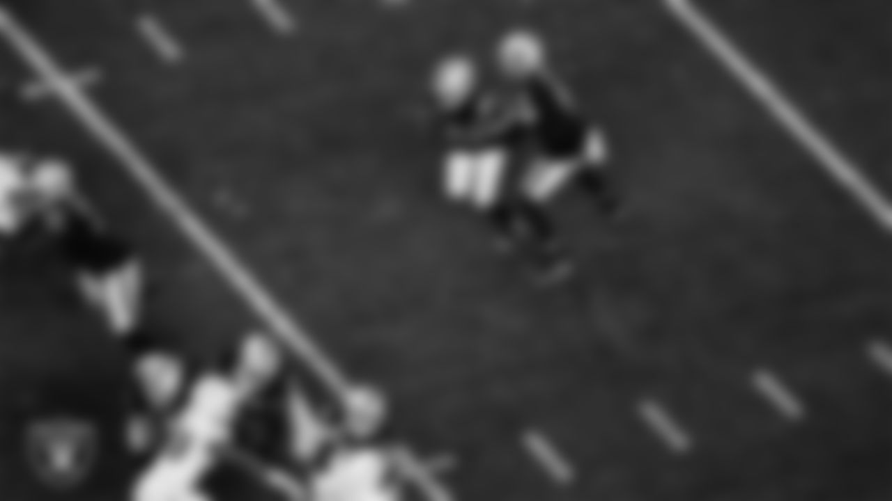 Las Vegas Raiders quarterback Derek Carr (4) hands the ball off to running back Josh Jacobs (28) during the regular season home game against the Los Angeles Chargers.