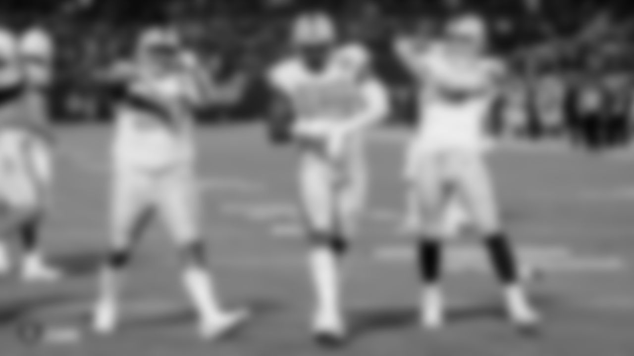 Raiders defensive tackle Johnathan Hankins (90), defensive end Clelin Ferrell (96) and defensive end Maxx Crosby (98) celebrate after Ferrell sacked the quarterback during the regular season game against the Los Angeles Chargers.