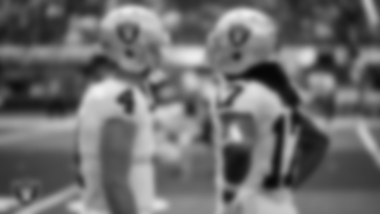 Las Vegas Raiders quarterback Derek Carr (4) and wide receiver Davante Adams (17) on the sidelines during the regular season away game against the Los Angeles Chargers at SoFi Stadium.