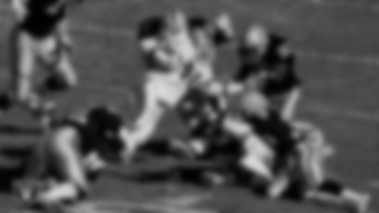 Raiders linebacker Linden King (52), defensive back Eddie Anderson (33) and defensive back Terry McDaniel (36) make a tackle during the regular season home game against the Denver Broncos at Los Angeles Memorial Coliseum, Saturday, December 3, 1989, in Los Angeles, Calif.