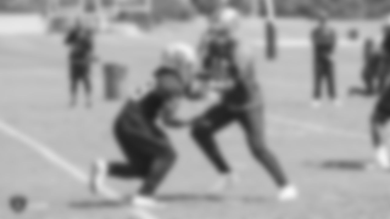 Oakland Raiders quarterback AJ McCarron (15) and running back Doug Martin (28) on the field for practice at the Oakland Raiders Practice Facility, Monday, September 3, 2018, in Alameda, California.