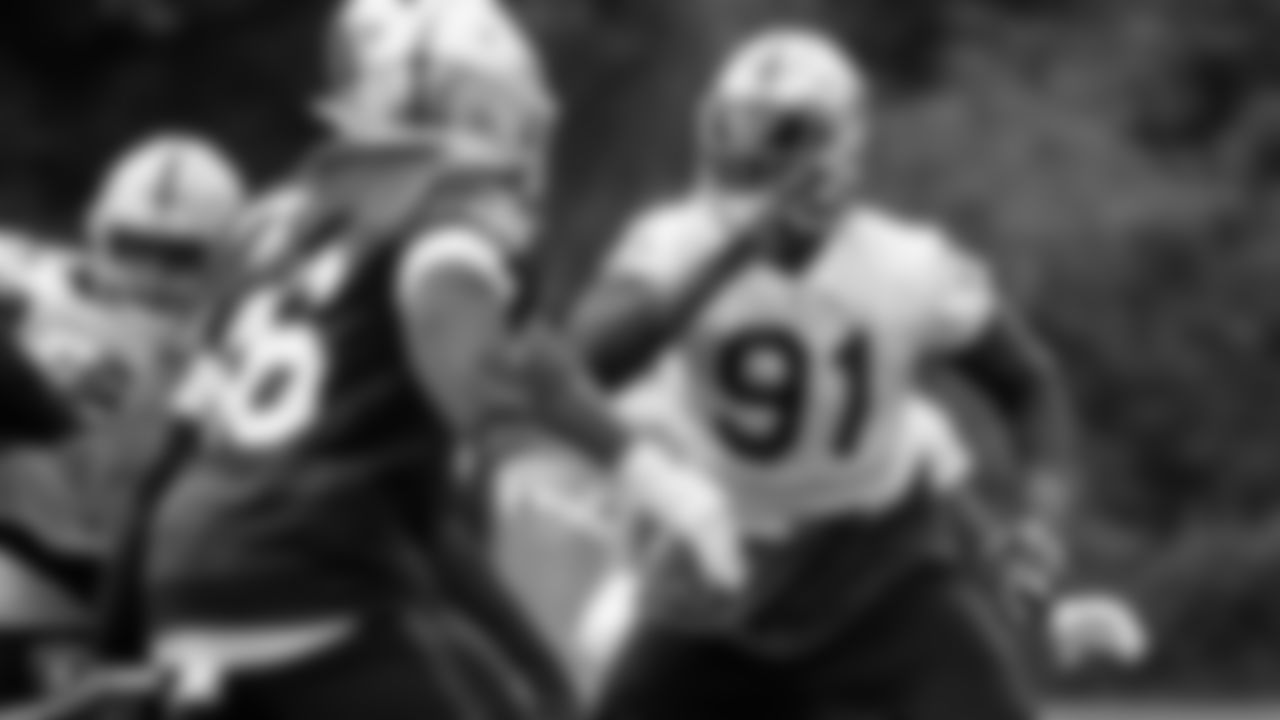 Raiders defensive end Benson Mayowa (91) rushes the quarterback on the field during practice.