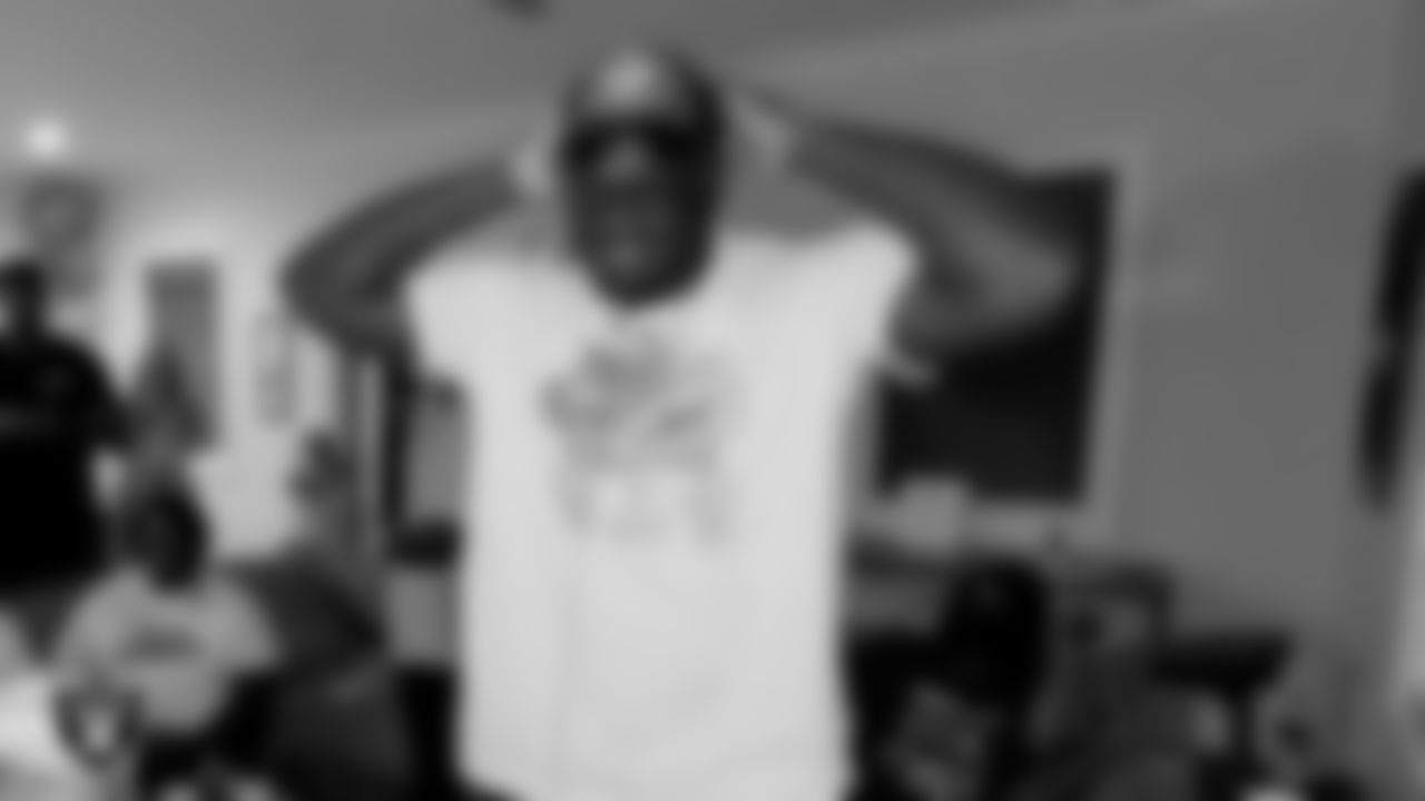 Alabama offensive lineman Alex Leatherwood outs on a Las Vegas Raiders cap after being selected with the 17th pick during the first round of the 2021 NFL Draft.