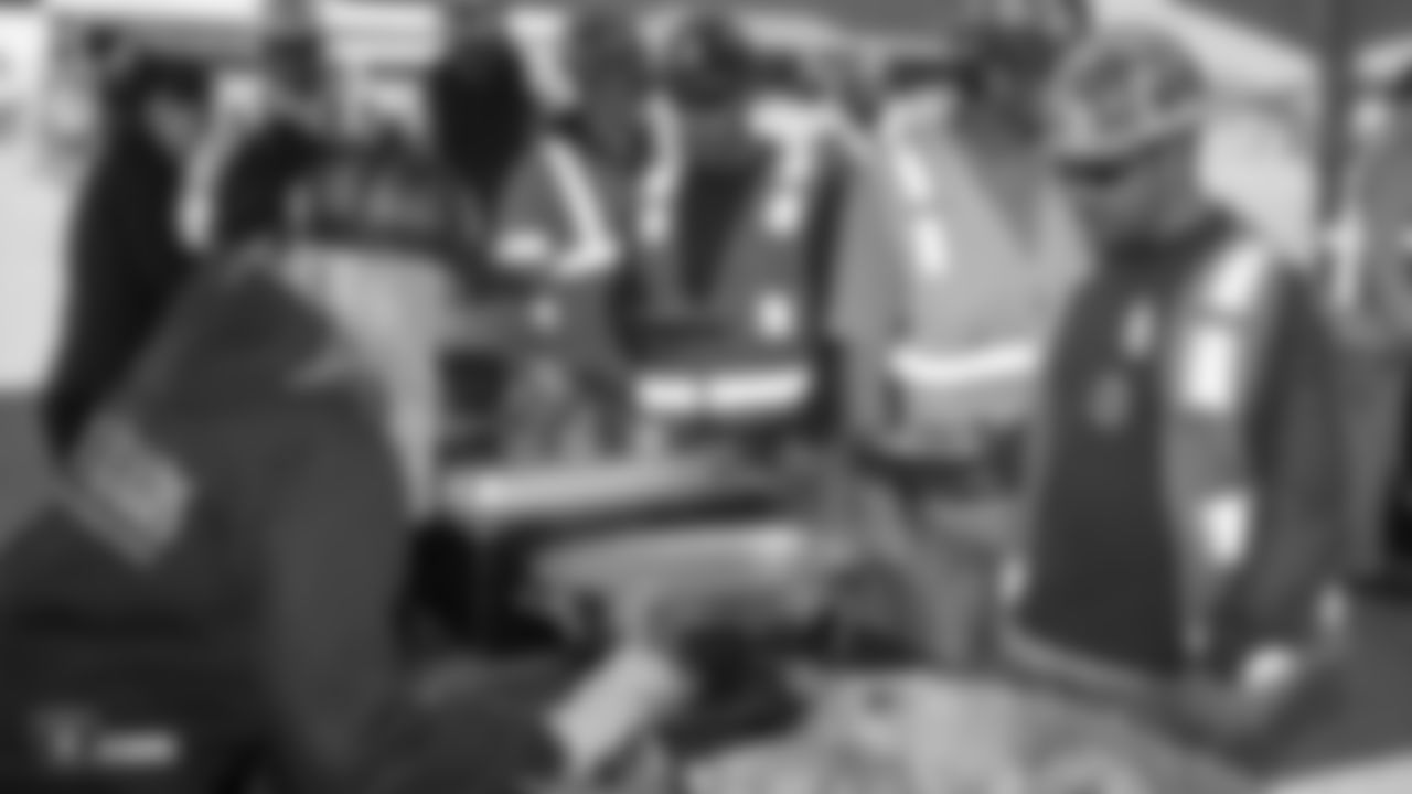 Construction workers of the Raiders Headquarters and Intermountain Healthcare Performance Center worksite get food during a lunch hosted by the Raiders front office.