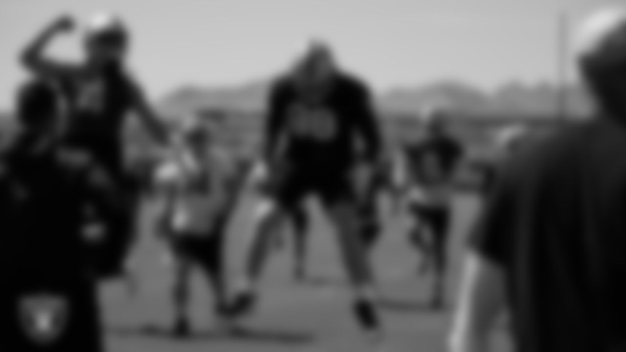 Las Vegas Raiders quarterback Derek Carr (4) and defensive end Maxx Crosby (98) at an Organized Team Activity (OTA).