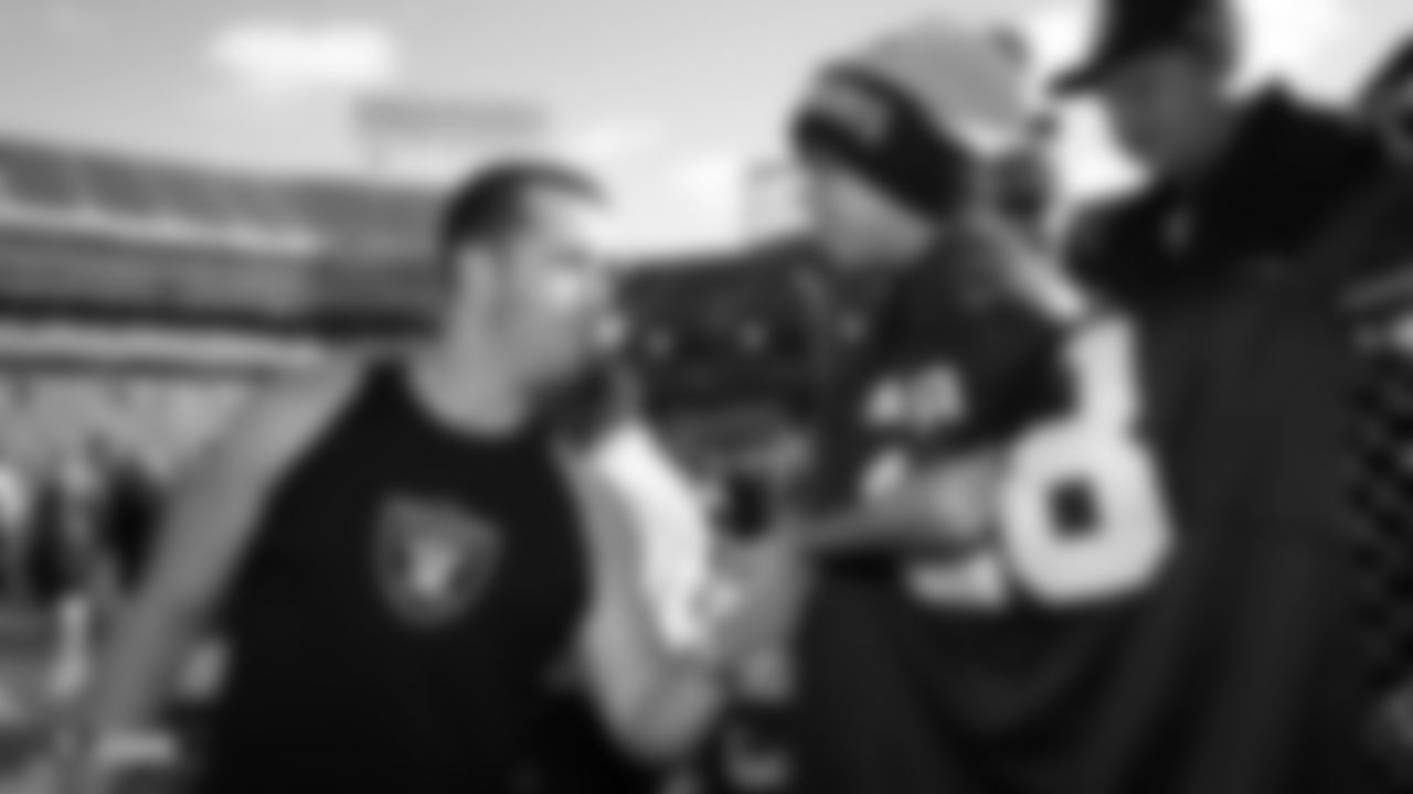 Raiders quarterback Derek Carr (4) shakes hands with a young fan before the regular season game against the Jacksonville Jaguars.