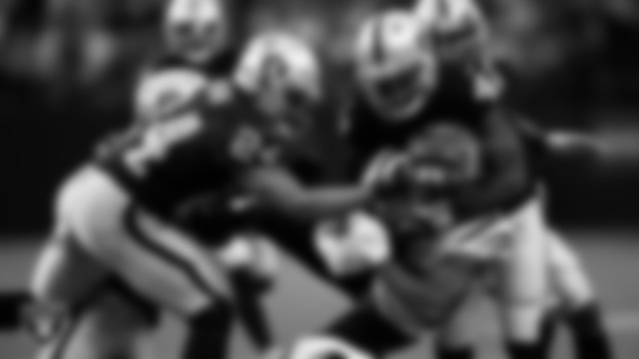 Las Vegas Raiders safety Johnathan Abram (24) and linebacker Cory Littleton (42) make a tackle during the regular season home game against the Cincinnati Bengals.
