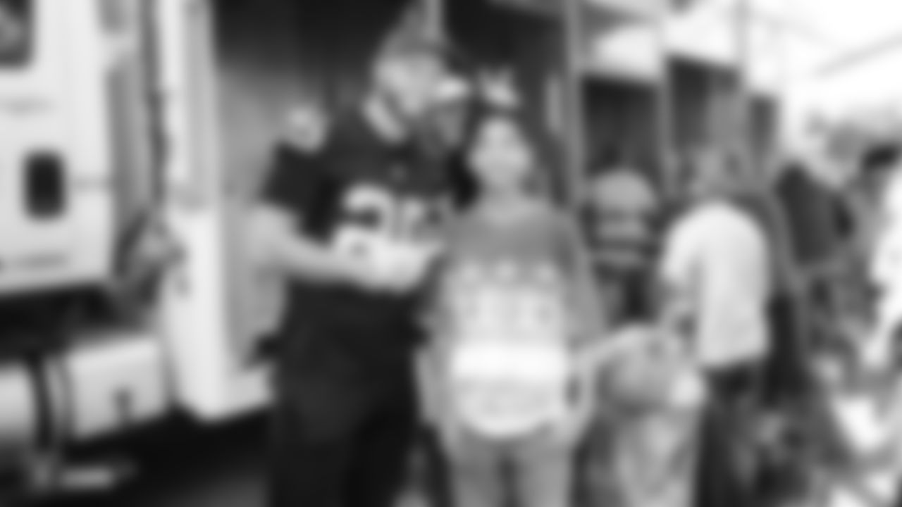 Oakland Raiders players work with the Alameda County Community Food Bank Mobile Pantry to sort and distribute food to low-income families at Ashland Village Apartments, Tuesday, September 18, 2018, in San Leandro, California.