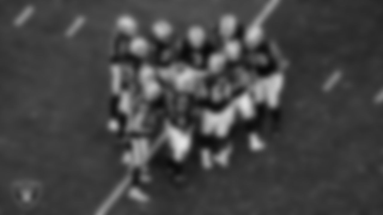 The Las Vegas Raiders offense huddle during the regular season home game against the San Francisco 49ers at Allegiant Stadium.