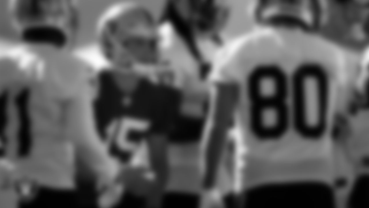 Las Vegas Raiders quarterback Chase Garbers (15) in a huddle on the field for practice at 2022 Training Camp at Intermountain Healthcare Performance Center.