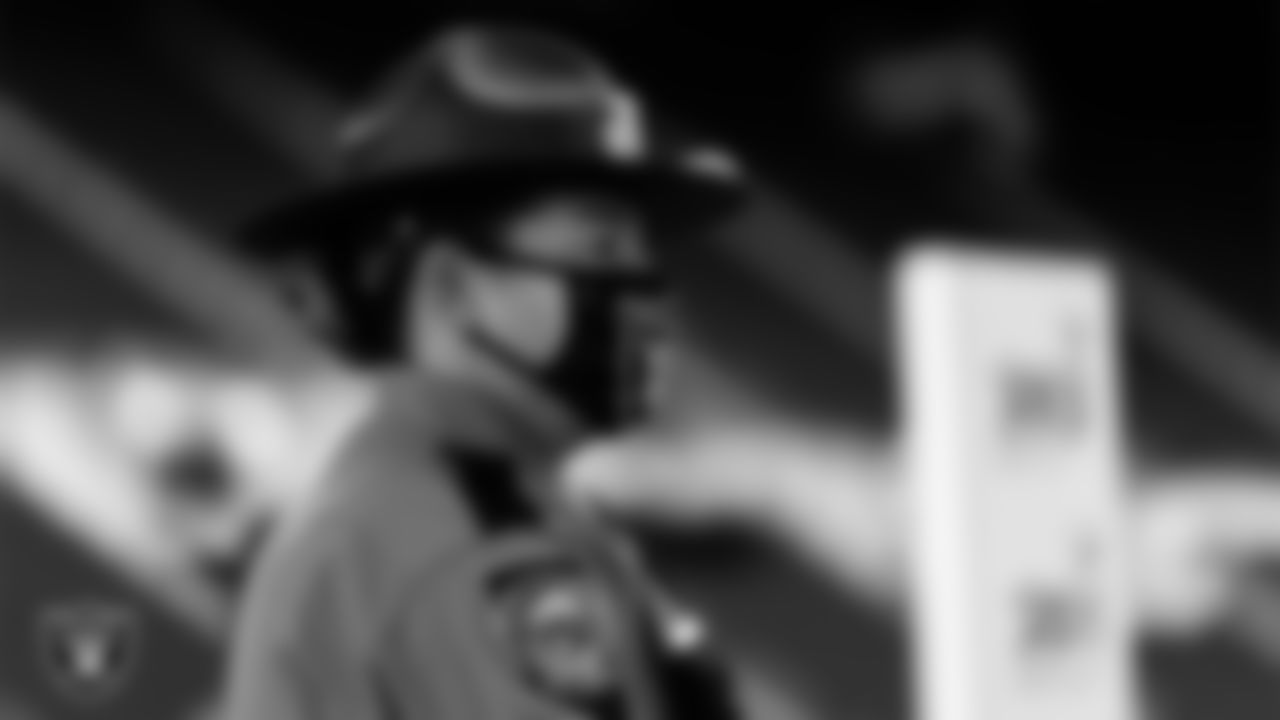 A member of the Nevada Highway Patrol waits to light the Al Davis Memorial Torch before the Las Vegas Raiders regular season home game against the Indianapolis Colts.