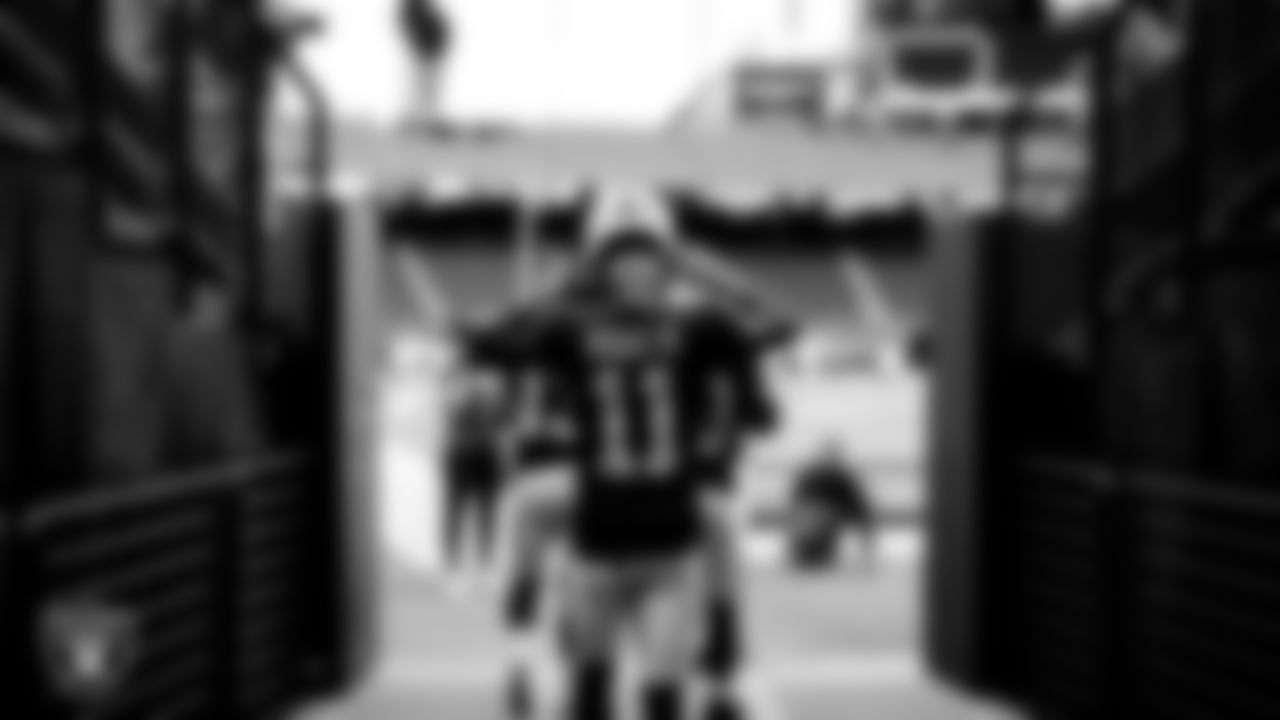 The Raiders walk down the tunnel before the regular season game against the Denver Broncos at Allegiant Stadium.