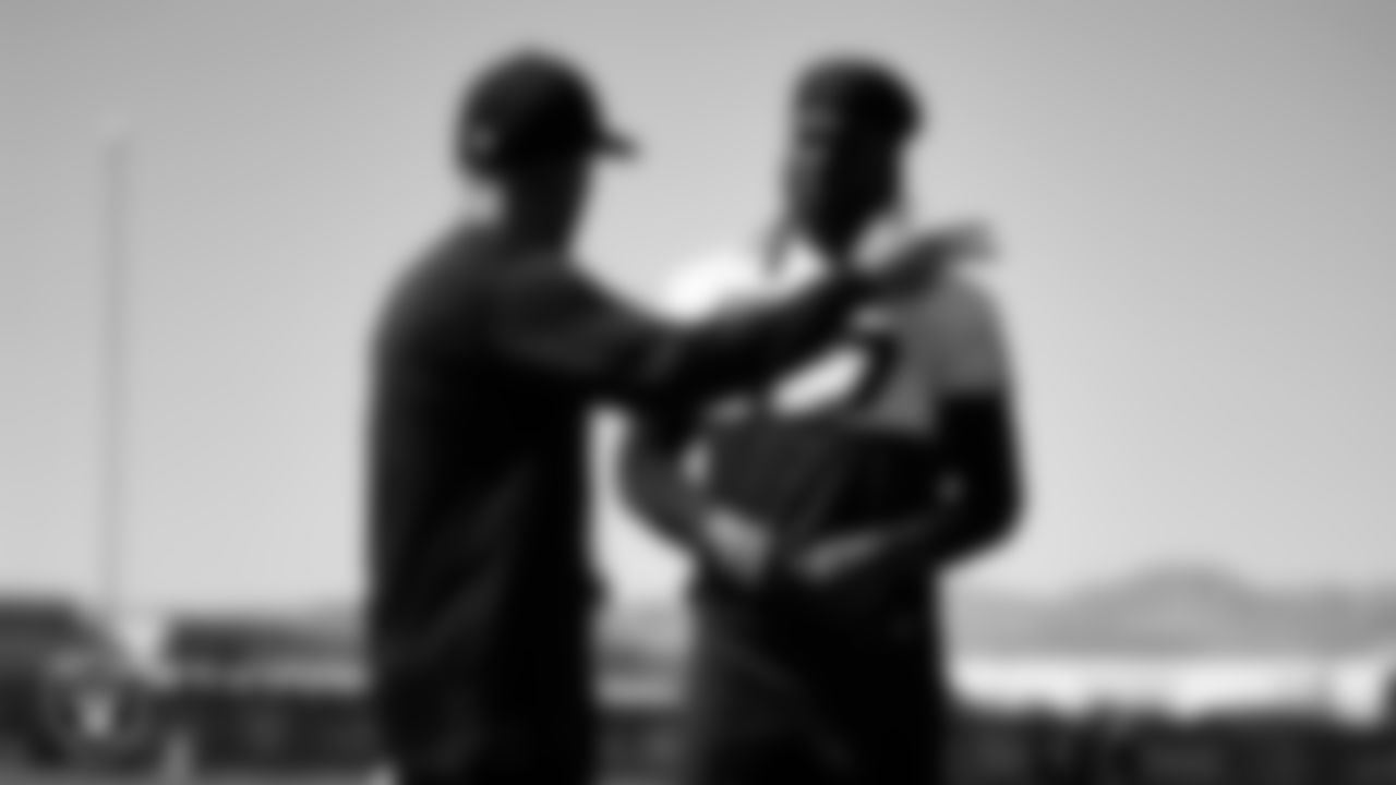 Las Vegas Raiders offensive coordinator Mick Lombardi and wide receiver Davante Adams (17) at an Organized Team Activity (OTA).