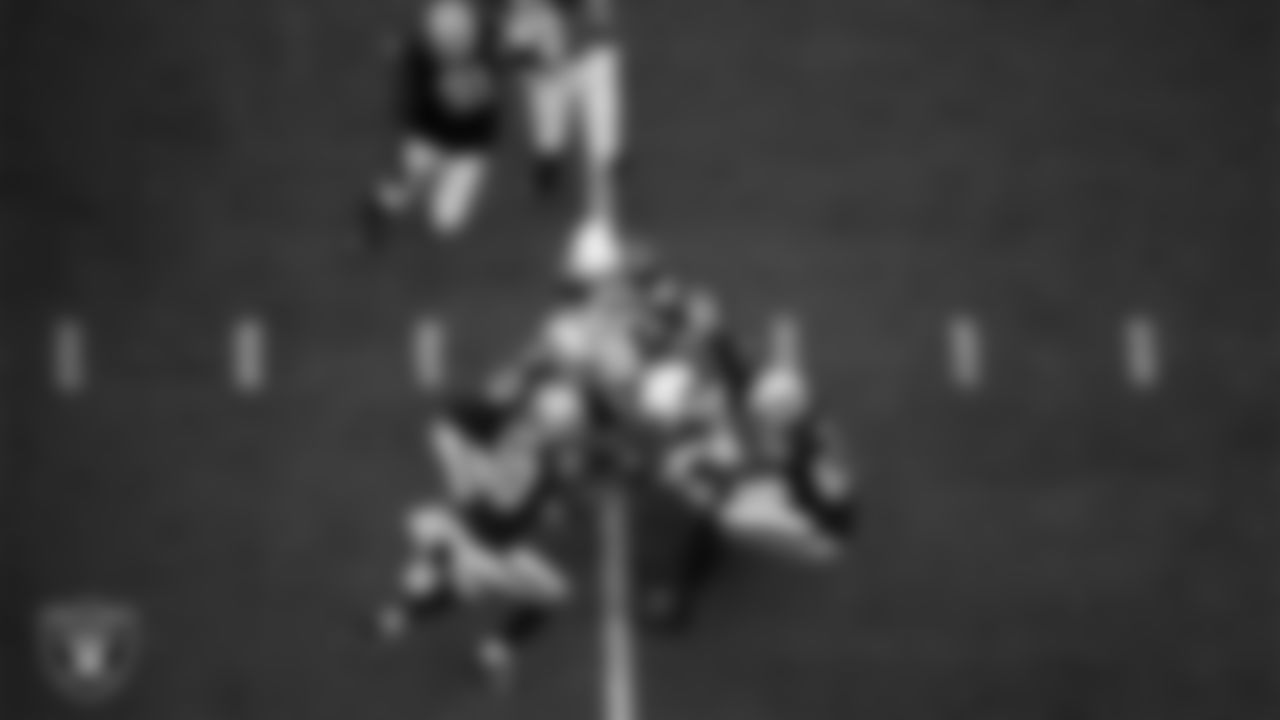 Las Vegas Raiders linebacker Jayon Brown (50), safety Duron Harmon (30), safety Johnathan Abram (24) and defensive end Chandler Jones (55) make a tackle during the regular season home game against the Arizona Cardinals at Allegiant Stadium.
