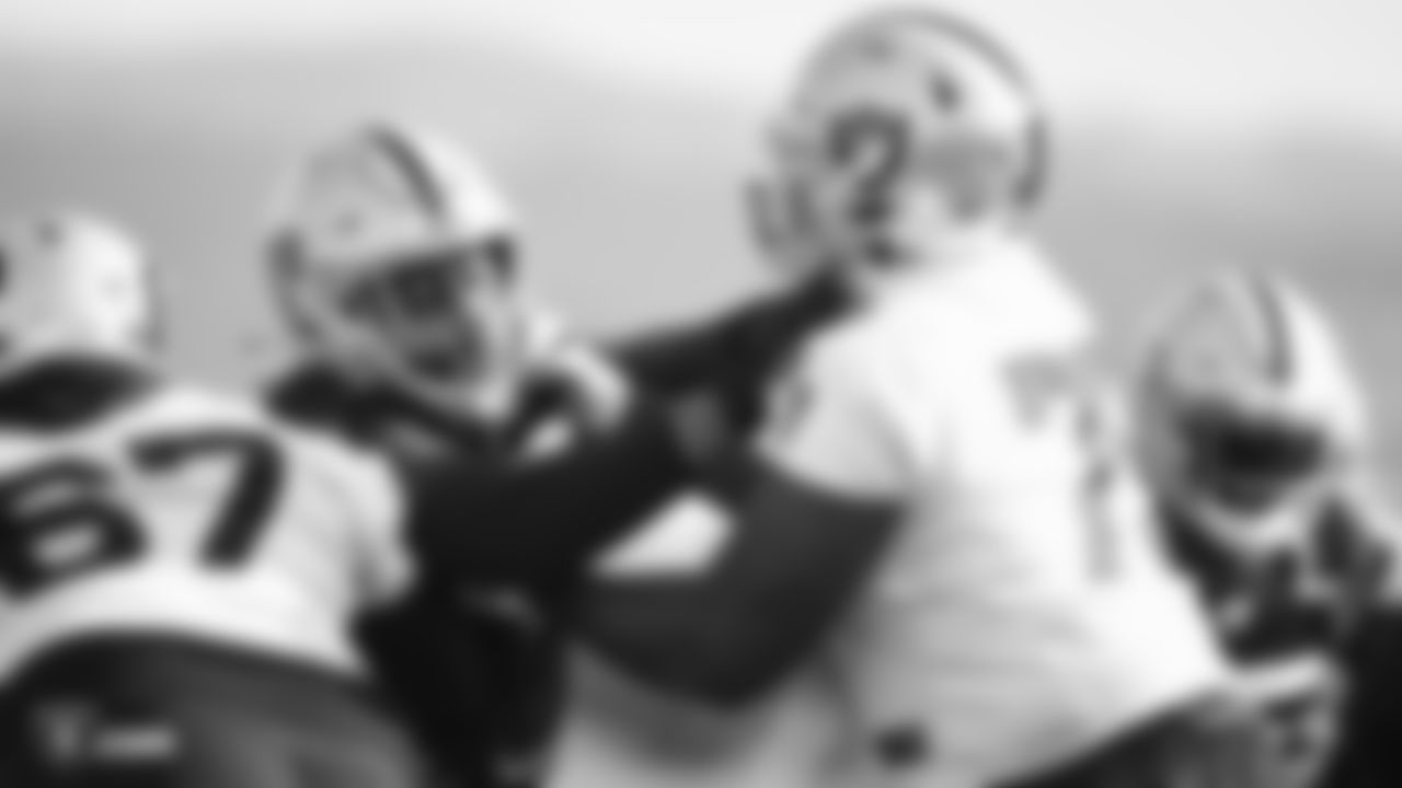 Raiders defensive tackle P.J. Hall (92) rushes the quarterback as tackle Brandon Parker (75) blocks during practice.