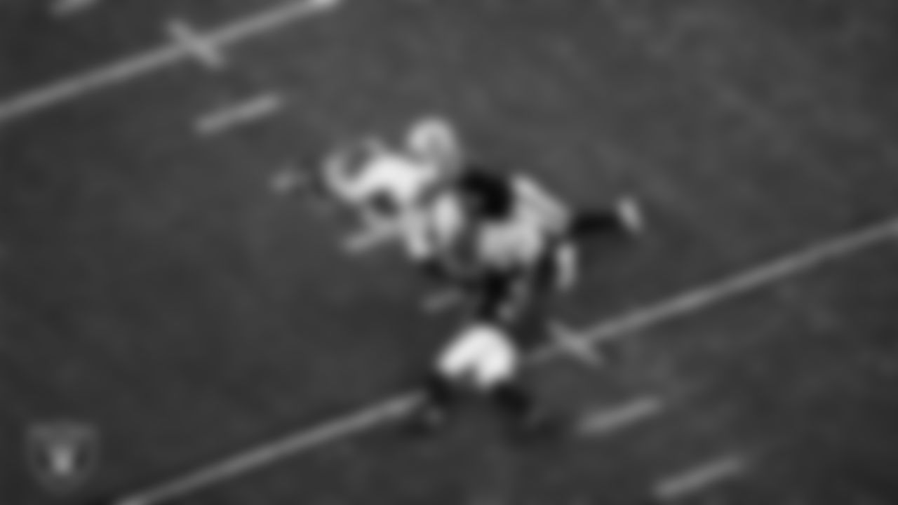 Las Vegas Raiders linebacker Denzel Perryman (52) and cornerback Nate Hobbs (39) make a tackle during the regular season home game against the Washington Football Team.