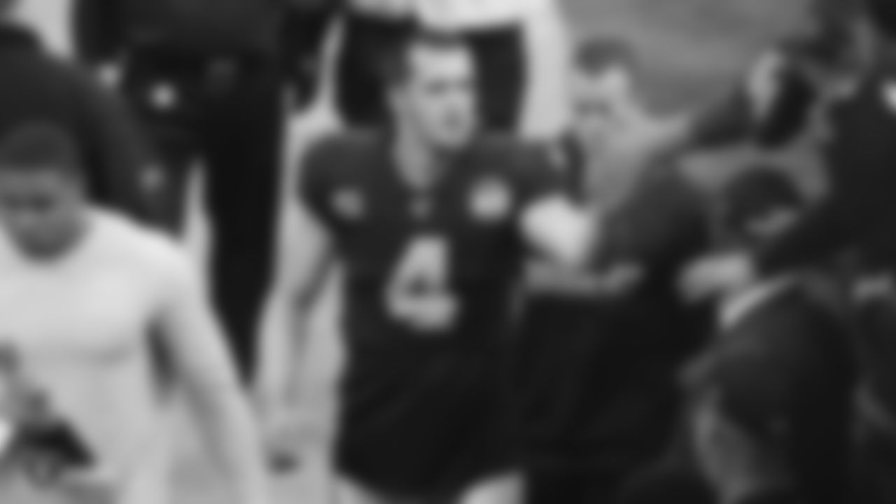 Raiders quarterback Derek Carr (4) high fives fans after the regular season game against the Jacksonville Jaguars.