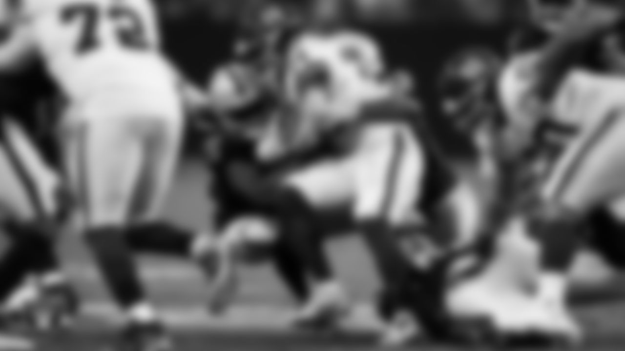 Las Vegas Raiders linebacker Divine Deablo (5) and linebacker Denzel Perryman (52) make a tackle during the regular season home game against the Washington Football Team.