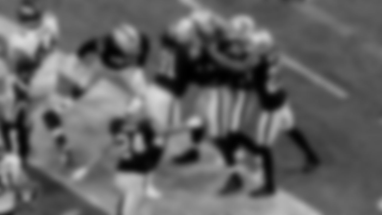 Las Vegas Raiders defensive end Carl Nassib (94) is congratulated by teammates after an interception during the regular season game against the Denver Broncos at Allegiant Stadium.