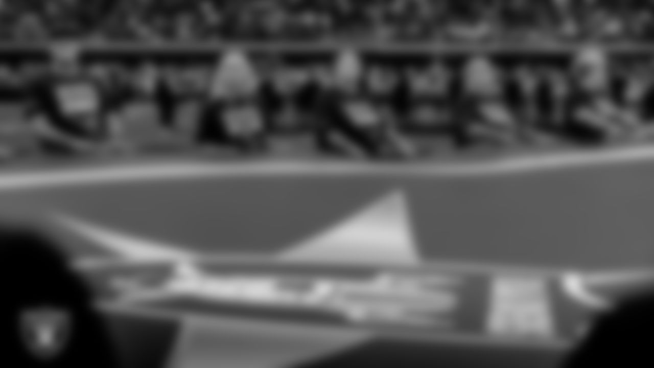 First responders hold Vegas Strong flags on the field in commemoration of 1 October before the Las Vegas Raiders' regular season home game against the Denver Broncos at Allegiant Stadium.
