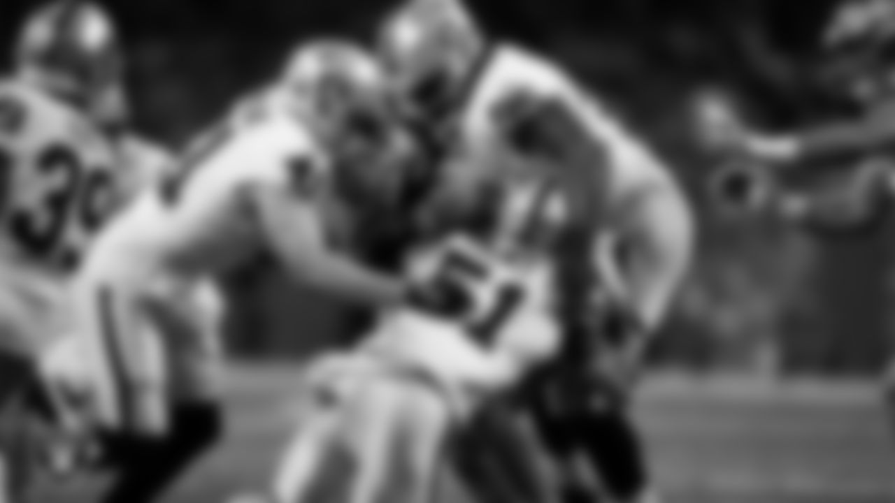 Las Vegas Raiders linebacker Robert Spillane (41), defensive end Malcolm Koonce (51) and defensive tackle John Jenkins (95) make a tackle during the regular season away game against the Detroit Lions at Ford Field.